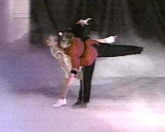 Claire and the Prince skating as a pair in a camel position