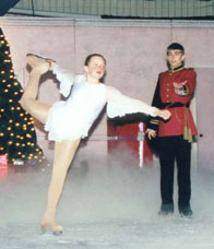 Princess skates an arabesque while the prince watches