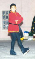 A Russian dancer stands with his arms crossed and one foot in front
