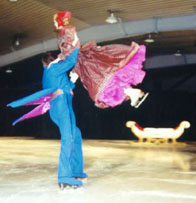 A Waltzer sweeps his partner off her feet into the air