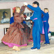 A Waltzing couple holds hands getting ready to spin
