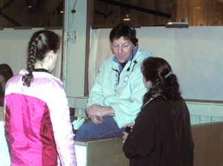 Larry sitting on the boards talking to two skaters