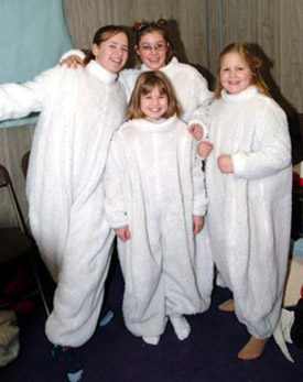 four skaters posing in their rat suits