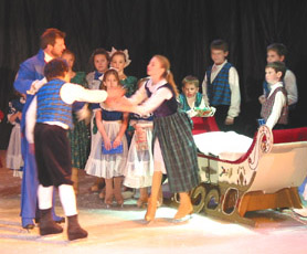 Clara and Fritz fight over the doll while a group of children stand behind and watch.  An adult skater is close to Clara and Fritz. 